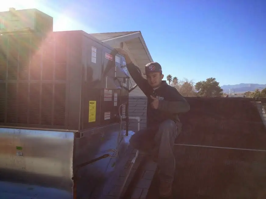 HVAC technician performing Air Duct Repair on a rooftop unit in Streetsboro